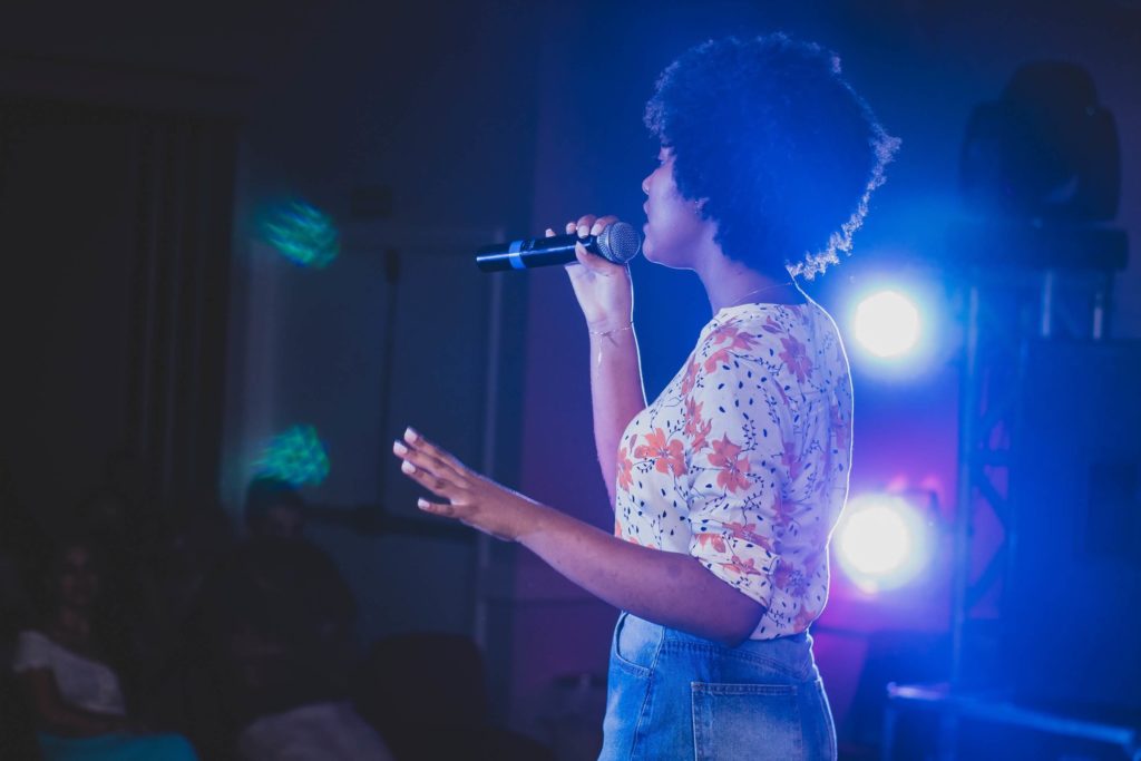 woman singing karaoke on stage