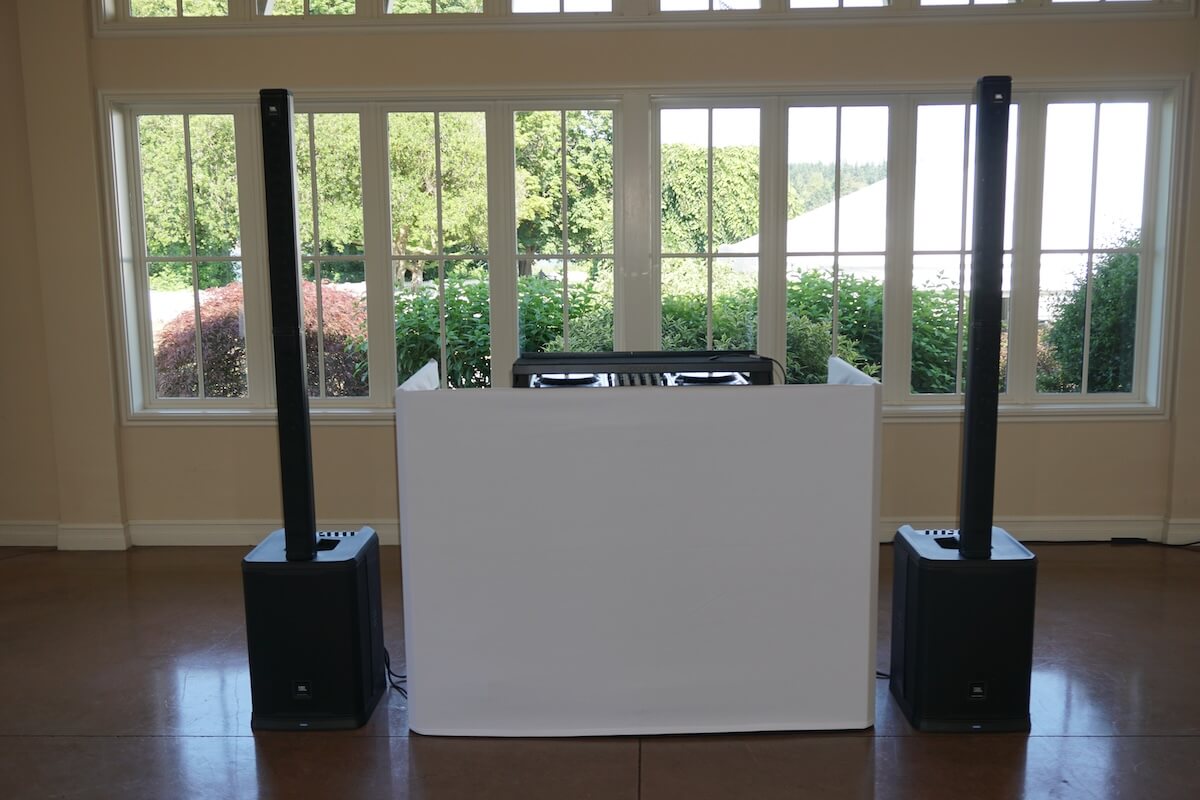 dj booth with speakers and a controller setup