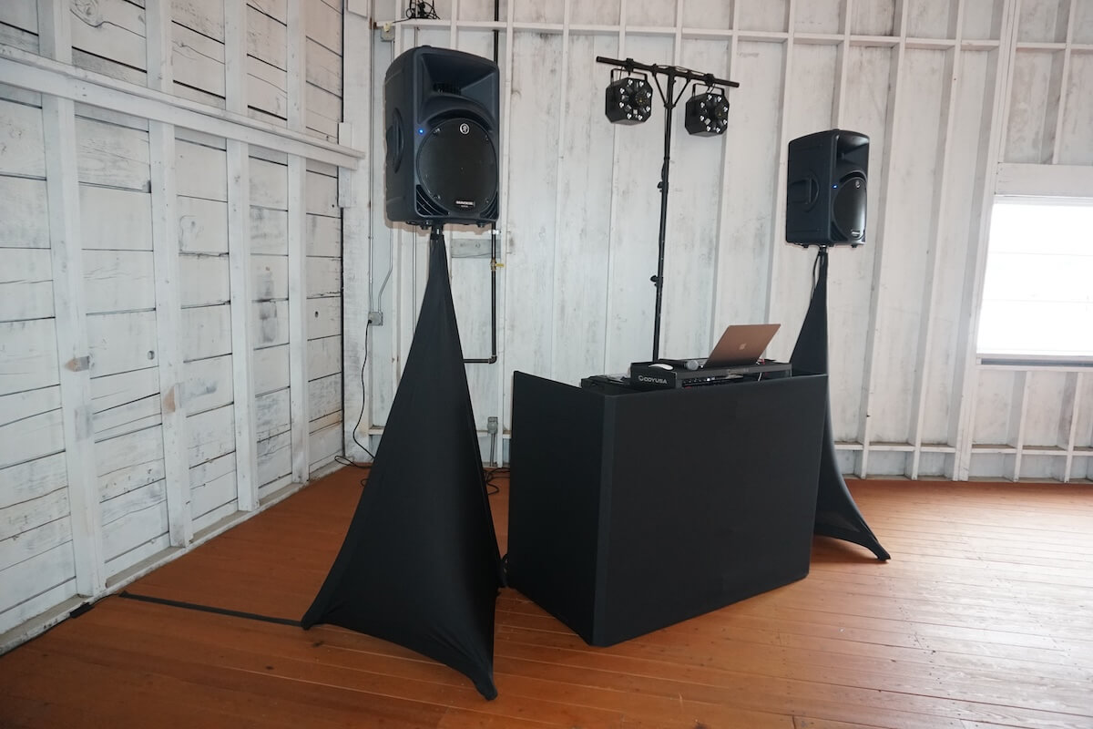 DJ booth with Mackie speakers and dance lighting